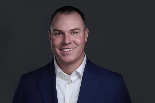 Senior executive headshot with composed expression