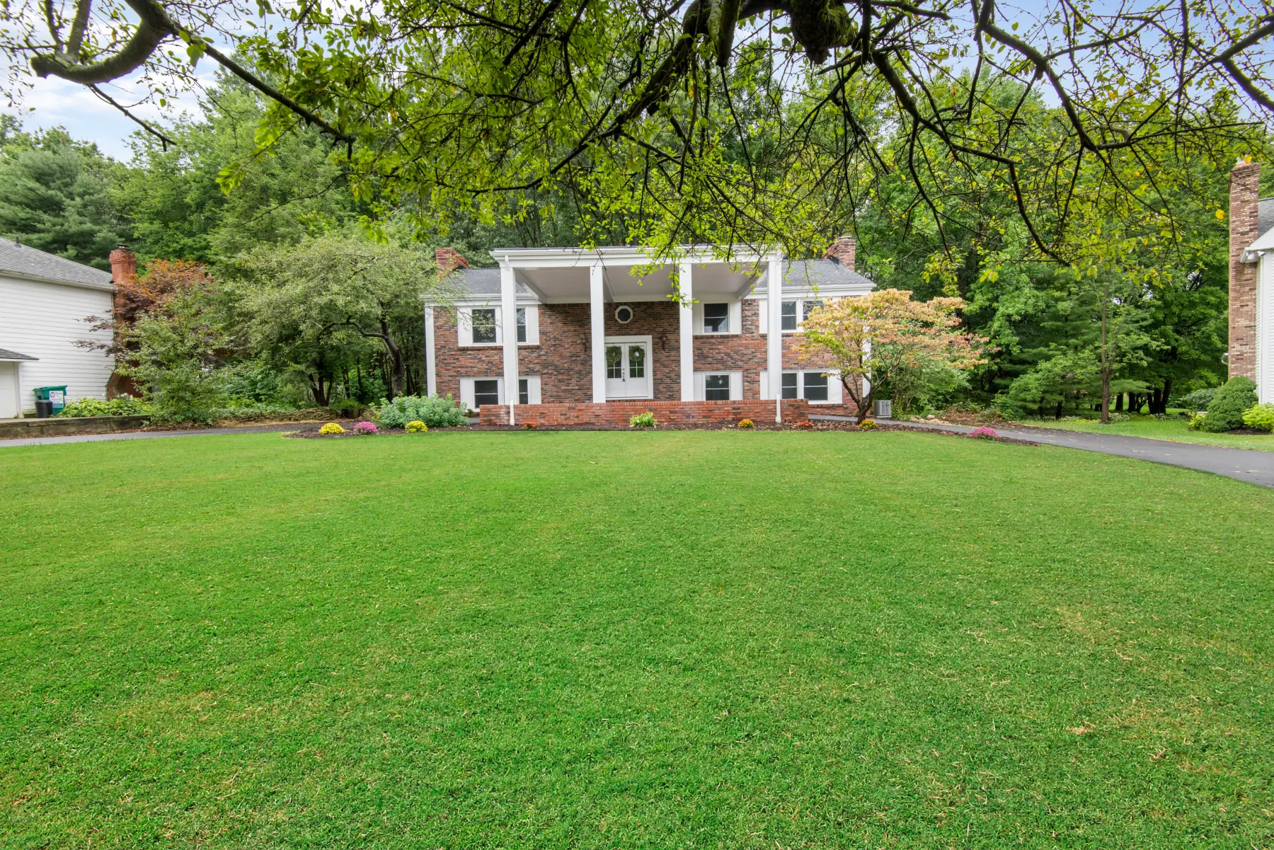 Brick home on a tree-lined property photographed in Uniontown, Ohio
